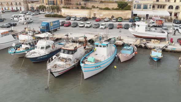 Aerial Shot Of Bobbing Docked Fleet in Marsaxlokk Port Malta