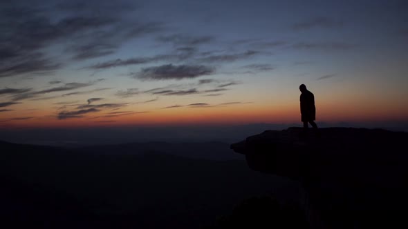 Hiker approaches McAfee Knob at sunrise