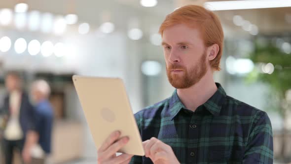 Portrait of Beautiful Beard Redhead Man Using Digital Tablet 