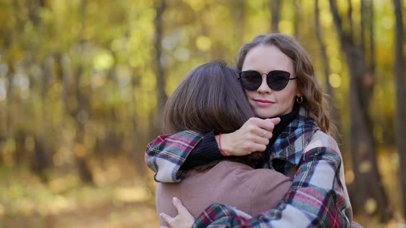 Woman is Embracing Her Boyfriend on Street in Autumn Day Romantic Date in Park