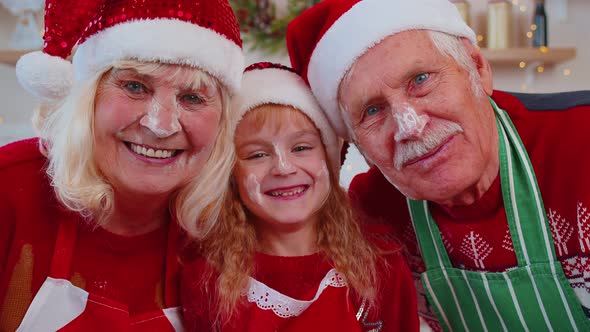 POV of Senior Grandparents with Granddaughter Kid Taking Selfie on Mobile Phone on Christmas Kitchen