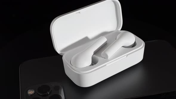 White Wireless Headphones on a Black Background