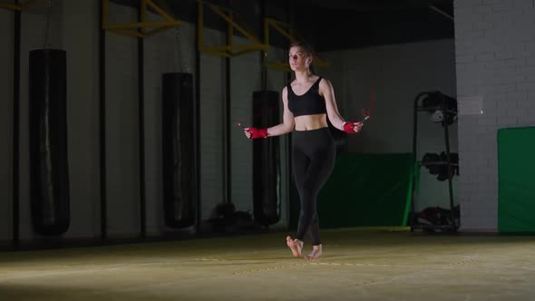 Kickboxing Coordination Training Young Female Fighter Jumps on a Rope Strength Fit Body