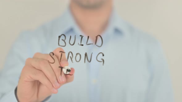 Build Strong Team, Man Writing on Transparent Screen