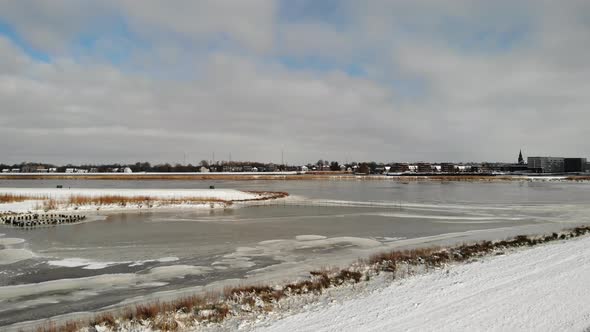 Person Walking At Frosted Countryside With Icy Lake At Crezeepolder In South Holland, Netherlands Ag