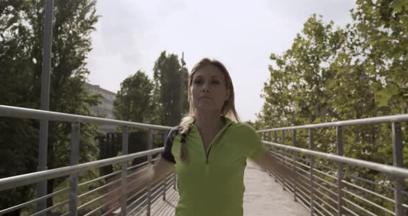 Young Blond Woman in Fitness Wear Warming Up Stretching for Running Training