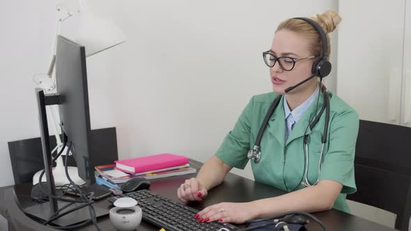 Beautiful Female Doctor Having Online Conversation with a Patient