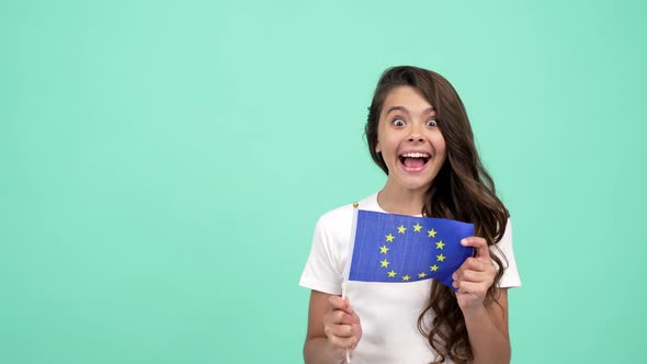 Surprised Child Waving European Union Flag on Blue Background Showing Thumb Up Schengen Visa