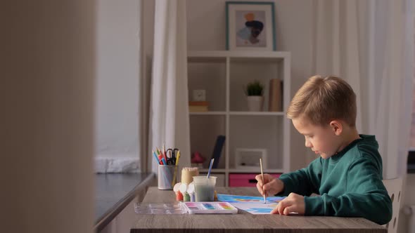 Little Boy with Colors Drawing Picture at Home