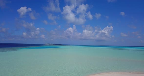 Wide birds eye abstract view of a white sandy paradise beach and blue ocean background in hi res 4K