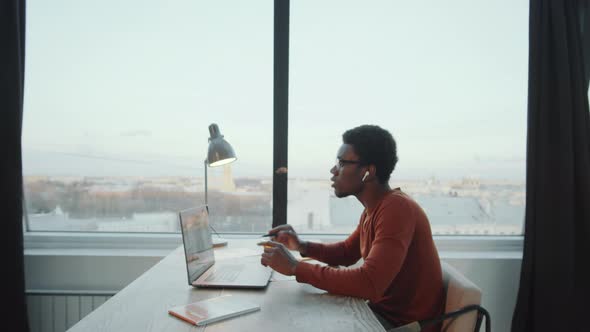 Afro Businessman Talking on Video Call in Rooftop Office