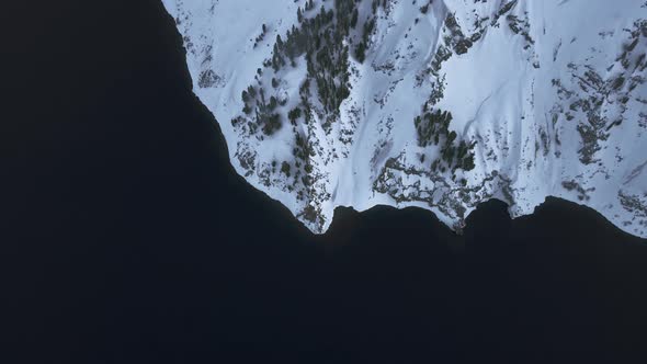 Overhead aerial shot of shore of Crater Lake, high angle drone view, Oregon, USA