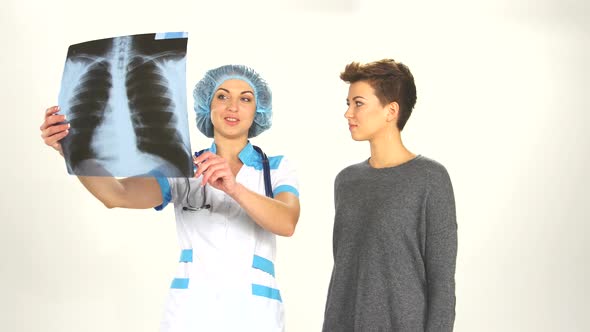 Female Doctor Looking at an X-ray with a Patient Woman