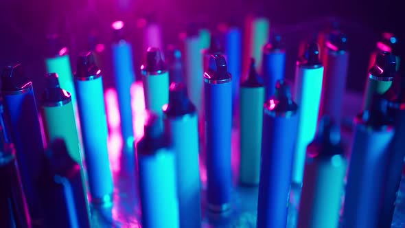 ECigarettes and Vapes with Smoke in Neon Lighting