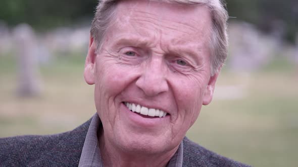 Elderly man smiling then laughing