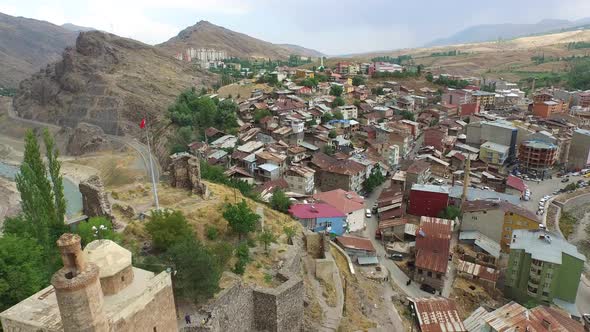 Old Fortress Walls and Watchtower of Castle Behind the Houses in the Small City