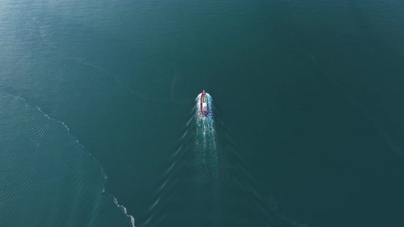 A fishing boat is moving forward on the beautiful sea