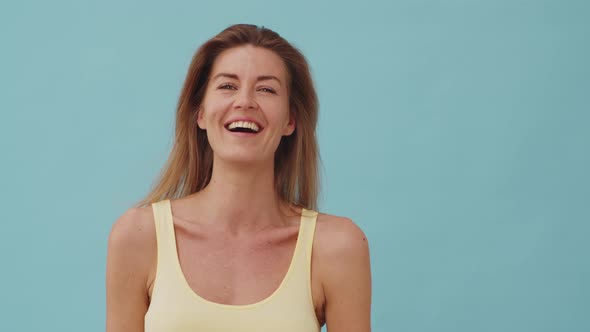 Woman with Dimpled Cheeks Laughing and Waving her Head