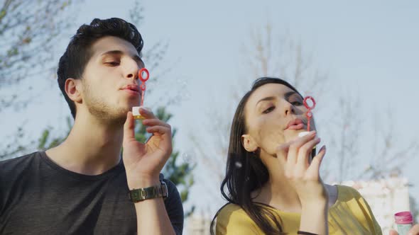 Man and woman making soap bubbles