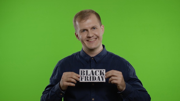 Happy Shopper Guy Showing Black Friday Inscription Note, Looking at Camera Amazed. Big Sale Day