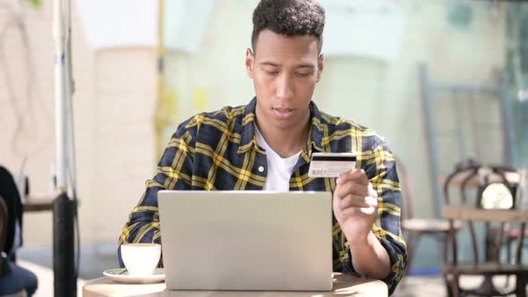 Upset Young African Man After Online Shopping Failure, Outdoor Cafe