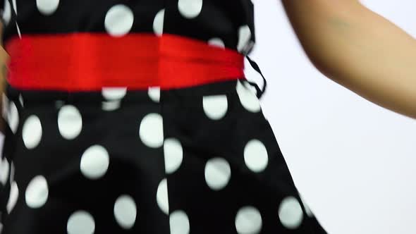 A Beautiful 50s Pin-up Girl Dances and Smiles at the Camera - Closeup - White Screen Background