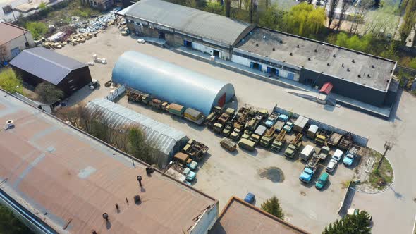Birds Eye View of an Old Storage Rooms with Broken Cars and Trucks