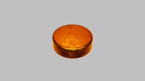 Golden hockey puck on white background.