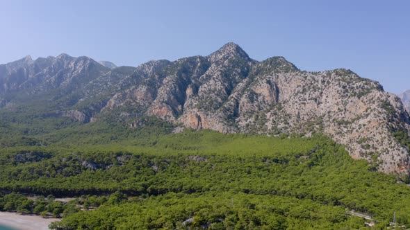 High Rocky Mountains on Blue Sky Background