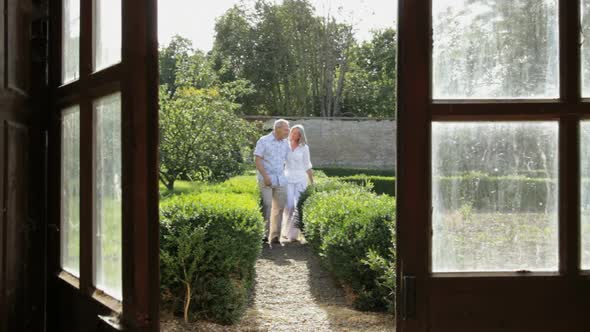 Mature couple walking in the garden