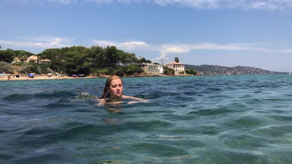 Caucasian  female on in the sea French riviera  4K 2160p UHD footage - Swimming in crystal clear  wa