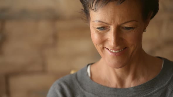 Face of Happy Mature Beautiful Woman Using Laptop