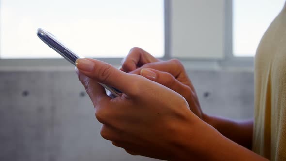 Executive using mobile phone in office