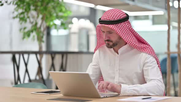 Professional Arab Businessman with Laptop Pointing at the Camera