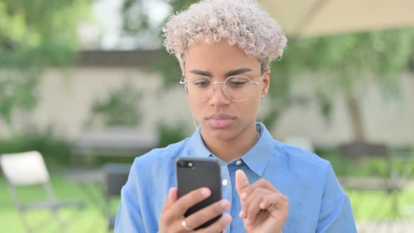 Portrait of Young African Woman Using Smartphone