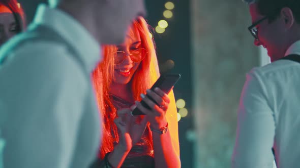 Portrait of Caucasian Blonde Girl Addicted to Phone While Dancing at Party