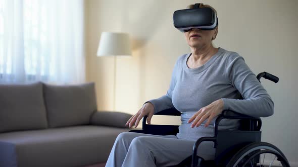 Aged Female Sitting in Wheelchair and Wearing Virtual Reality Headset, Game