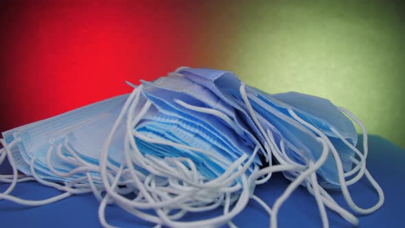 Blue Disposable Face Masks Lie on Table Under Electric Light