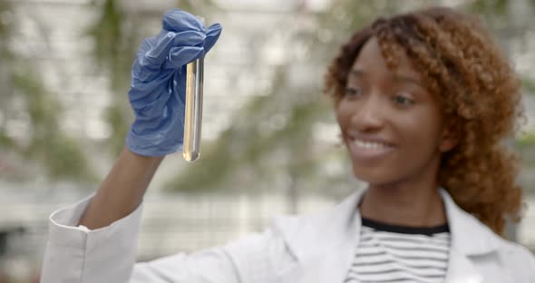 Girl is Holding Test Tube in Her Hand at Hot House