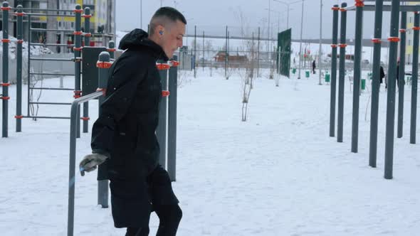 Man training outdoors on sports field in winter