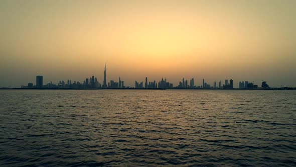 Grading aerial view of Dubai skyscrapers at sunset, UAE.