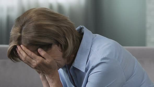 Woman Sitting in Depressed Mood, Upset by Crisis in Relationship With Husband