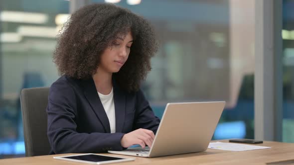 African Businesswoman Working on Laptop