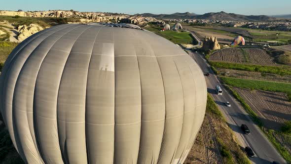 4K Aerial view of Goreme. Colorful hot air balloons fly over the valleys.