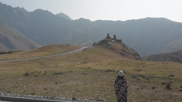 Woman With Gergeti Trinity Church.Log