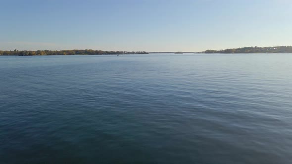 Aerial view over a lake, water with a boat sailing at the end, Lake Minnetonka Minnesota