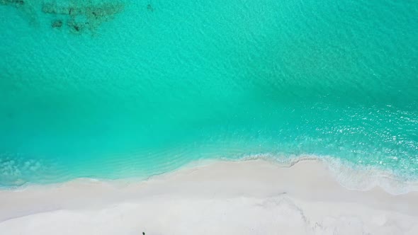 Aerial top down nature of exotic lagoon beach voyage by shallow lagoon with bright sandy background 