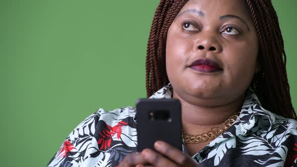 Overweight Beautiful African Woman Against Green Background