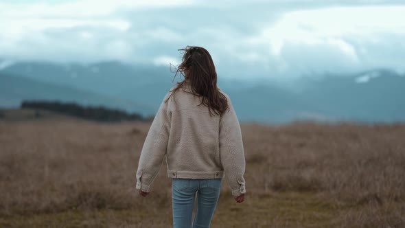 Outdoor Calmness Woman with Open Arms Enjoying Nature and Feeling Free Around Mountains