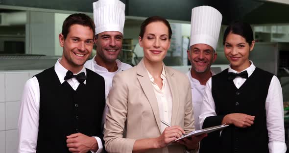 Happy Restaurant Staff with Manager Smiling at Camera